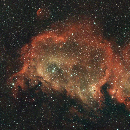 The soul nebula appears as a broad cavern-like area of glowing gases spanning this image, divided into left and right chambers, with pillars of dust reaching inward from the outer edges