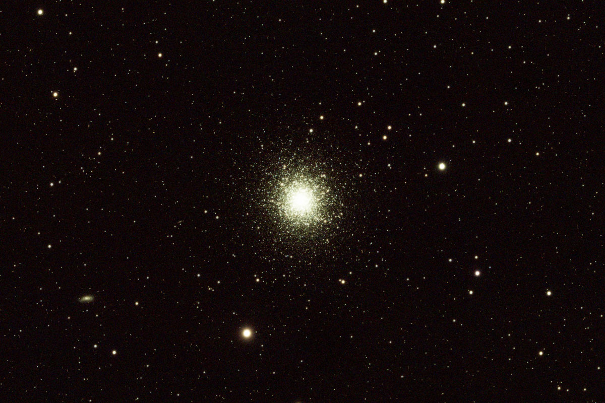 The Hercules globular cluster appears here in the centre of the image as a ball of countless stars growing brighter and more dense toward the centre
