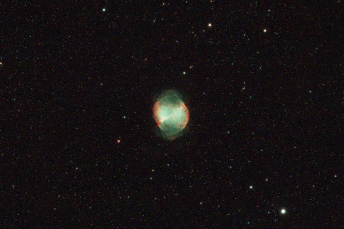 The Dumbbell nebula looks more egg-shaped in this image, with the red-coloured gases forming the eponymous dumbbell shape, and the remainder of the shell made up of green gases