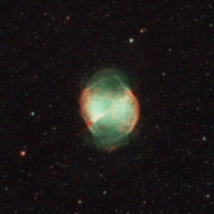 The Dumbbell nebula looks more egg-shaped in this image, with the red-coloured gases forming the eponymous dumbbell shape, and the remainder of the shell made up of green gases