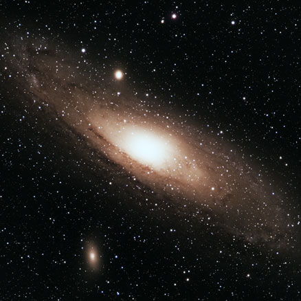 The Andromeda galaxy, showing dust lanes and nebulae in the spiral arms, with its two sattelite dwarf galaxies M32 and M110